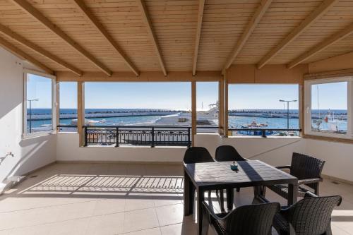 a dining room with a view of the ocean at Port house with amazing sea view and jacuzzi in Ierápetra