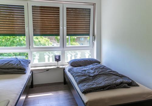 1 dormitorio con 2 camas y una ventana con persianas en Firmen-Familien-Villa, en Heiligengrabe