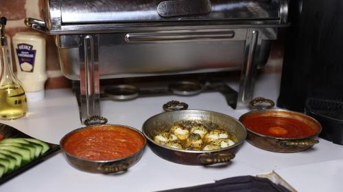 three pots of food sitting on top of a stove at Royal Tophane in Istanbul