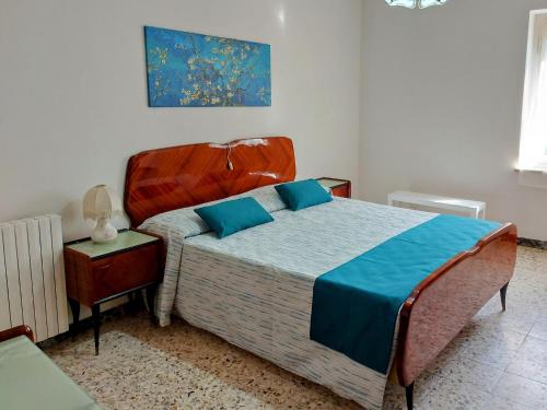 a bedroom with a large bed with blue pillows at La Casa sulle Mura - Montecarlo - A 15 km da Lucca in Montecarlo