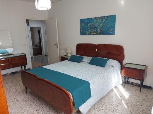 a bedroom with a large bed and a television at La Casa sulle Mura - Montecarlo - A 15 km da Lucca in Montecarlo