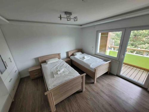 a room with two beds and a large window at House in Sarstedt! contactless check-in in Sarstedt