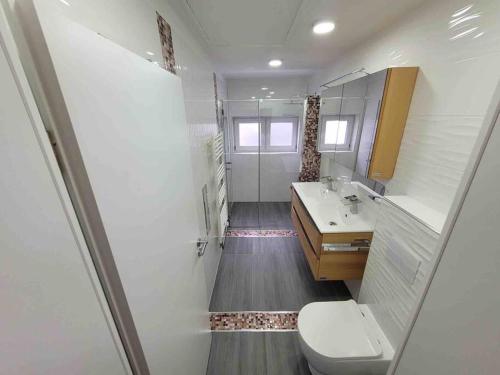 a bathroom with a toilet and a sink at House in Sarstedt! contactless check-in in Sarstedt