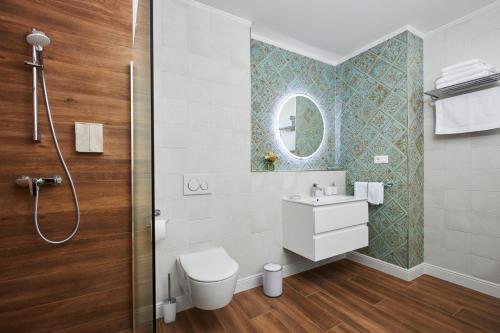 a bathroom with a toilet and a sink and a shower at Rustyfox in Remetské Hámre
