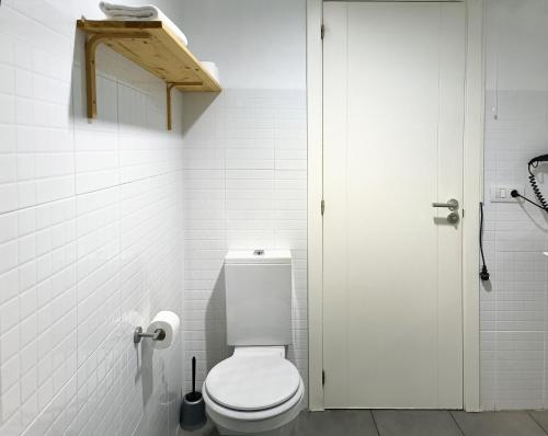 a white bathroom with a toilet and a shower at Flats Friends Tetuan in Valencia