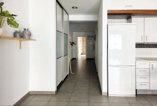 a kitchen with white cabinets and a tile floor at Flats Friends Tetuan in Valencia