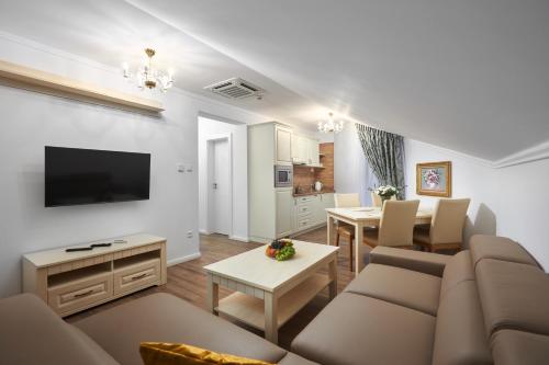 a living room with a couch and a dining room at Rustyfox in Remetské Hámre