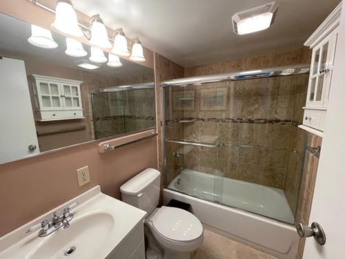 a bathroom with a sink and a toilet and a shower at Bikinis and Martinis at Dolphin Run-Oceanfront-Pool! in Virginia Beach
