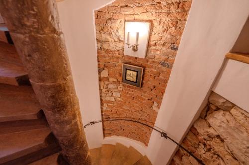 a staircase in a building with a brick wall at Traditional Prague Apartment in Prague