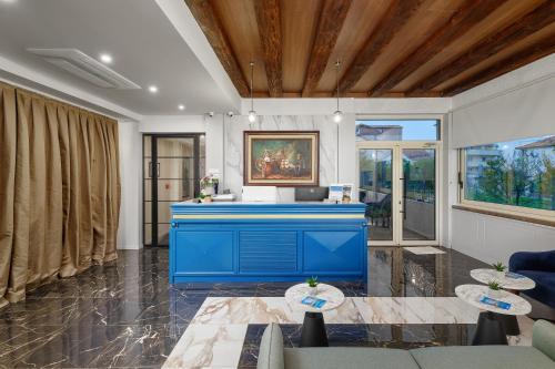 a living room with a blue desk and chairs at Hotel Splendido Bay in Tivat