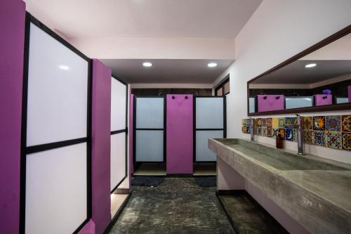 a hallway with purple doors in a room at Itza Hotel Akumal - Dive House in Akumal