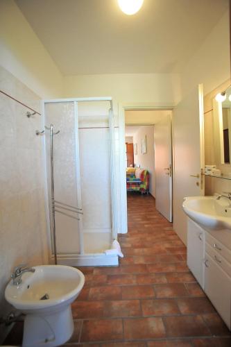 a bathroom with a shower and a toilet and a sink at Borgo Etrusco in Scarlino