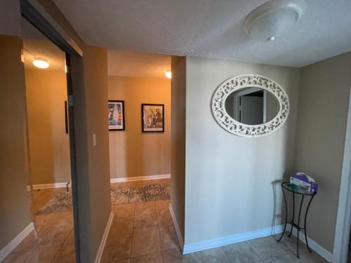 a hallway with a mirror on the wall at Playing Hooky at Dolphin Run-Oceanfront Condo-Pool in Virginia Beach