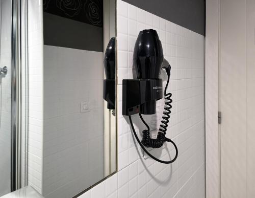 a black phone hanging on a wall in a bathroom at Flats Friends Tetuan in Valencia