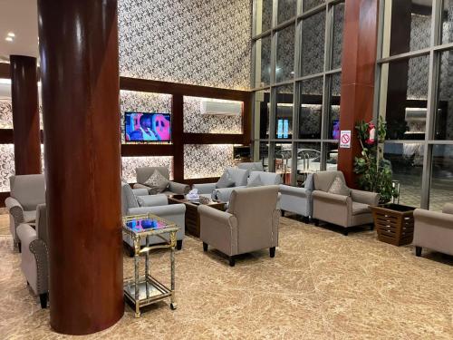 a waiting room with couches and chairs in a building at ليالي الين للشقق المخدومة in Buraydah