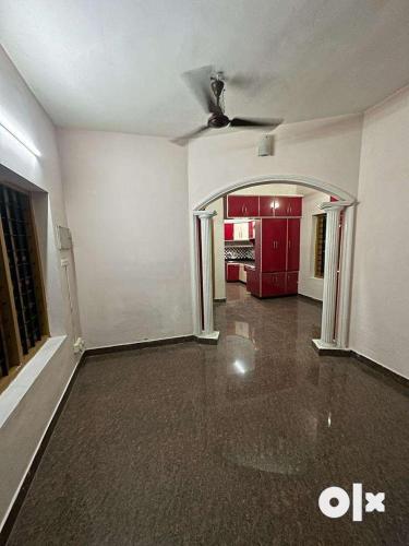 an empty living room with red cabinets and a ceiling at Edans home stay 