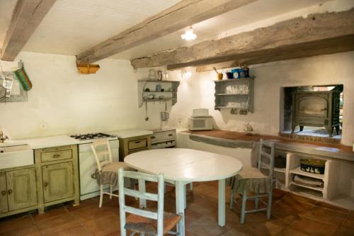 - une cuisine avec une table, une table et des chaises dans l'établissement Bergerie piscine privée, jacuzzi, à Montcuq