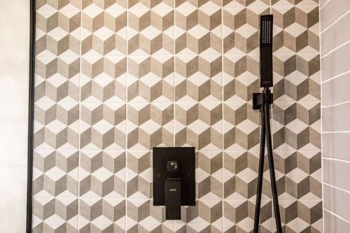 a bathroom with a urinal on a tiled wall at Mind- Tiny Home Venao Cove in Playa Venao