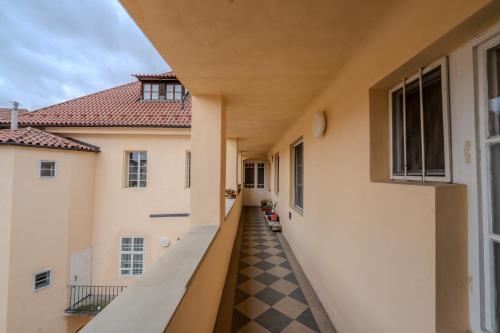a hallway of a building with a checkered floor at Charles Bridge Prague Apartment in Prague