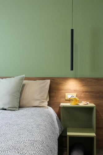 a bedroom with a bed with a nightstand next to it at B&B Gelso Rosso Pompei in Pompei
