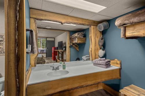 a bathroom with a sink and a mirror at Stonegate Lodge - Pool & Firepits Room #208 in Eureka Springs