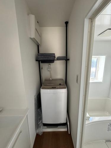 a small bathroom with a toilet and a sink at 枕木 New house with Huge View for Family-Group in Tokyo