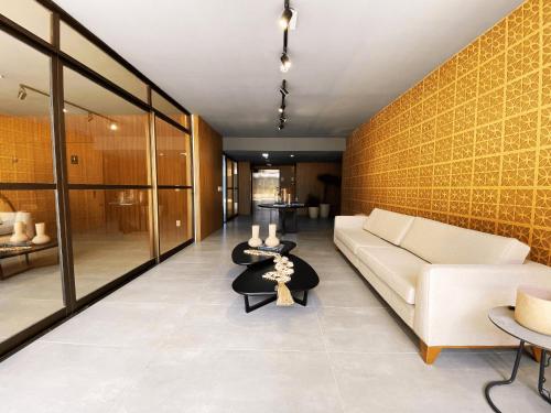 a living room with a white couch and a yellow wall at Flat FM20 Cabo Branco #L5 - By Almare in Tambaú