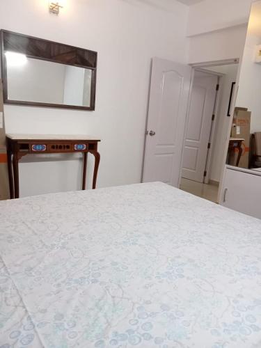 a bedroom with a bed and a mirror at Serena Casa in Mobor Goa