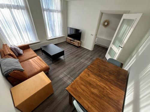 a living room with a couch and a table at 88 11City Appartement with Private free parking in Enschede