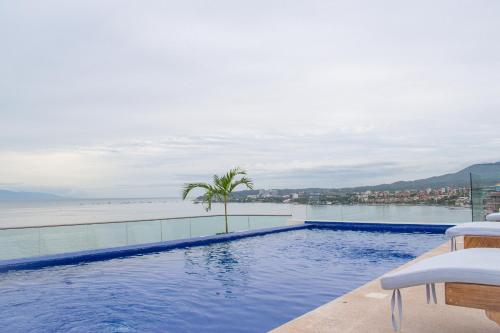 a swimming pool with a view of the water at MarAzul Beachfront Gem in Bucerías