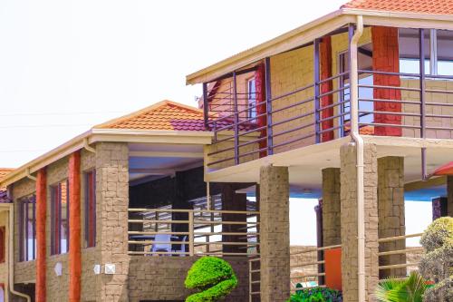 a large house with a balcony on the side of it at Jericho Hotel and Conferences in Thohoyandou