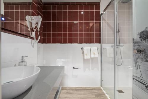 a bathroom with a shower and a tub and a sink at King David Suites by Homie in Funchal