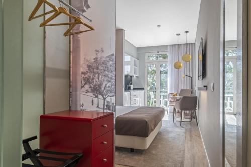 a bedroom with a bed and a red dresser at King David Suites by Homie in Funchal