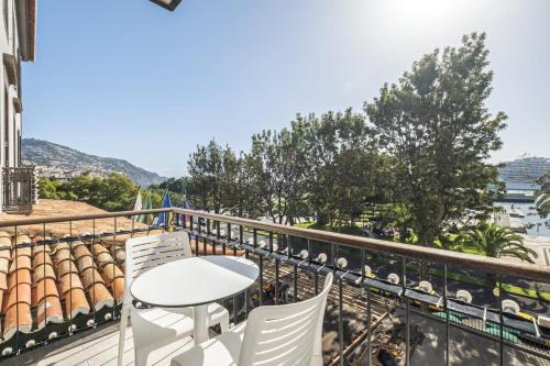 a balcony with a table and chairs and a view at King David Suites by Homie in Funchal