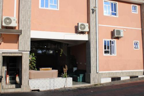 a pink building with speakers on the side of it at Gold Crown International Hotel With Complementary Breakfast and WiFi in Johannesburg