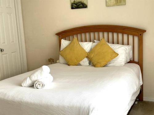 Una cama con almohadas amarillas y blancas. en Sunset themed retreat- Sleeps 10 en Davenport