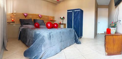 a bedroom with a bed with red balloons on it at Hotel Gran Riviera in Cartagena