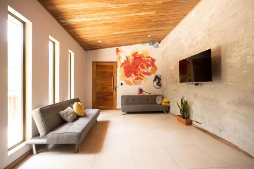 a living room with a couch and a tv at Gamai Full House Monteverde in Monteverde Costa Rica