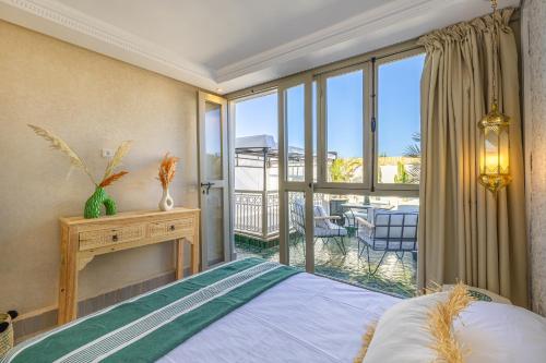 a bedroom with a bed and a balcony with a view at Riad Zahra b&b your private house in Marrakech in Marrakech