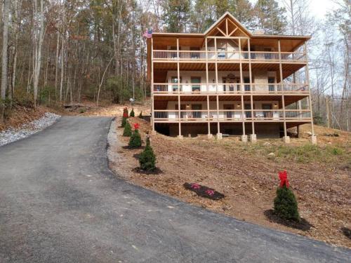 a house on the side of a road at The Grand Tennessean Cabin- Four Bedroom Luxury Cabin in the Mountains in Pigeon Forge