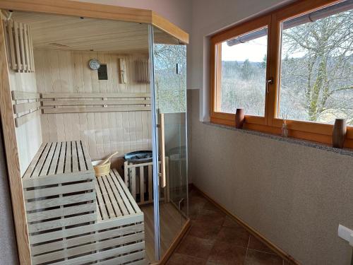 a walk in shower in a bathroom with a window at Gorski kotar , Kuća za odmor Kratohvil in Lukovdol