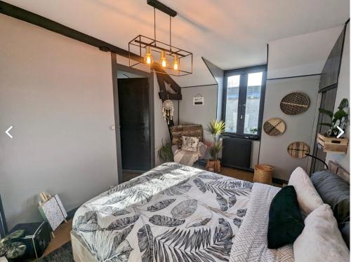 a bedroom with a bed and a couch in a room at Le Chaumontais Écolo et sa terrasse privée in Chaumont