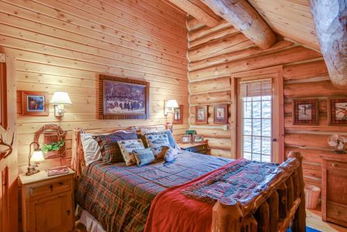 a bedroom with a bed in a log cabin at Handcrafted Log Home on River Near Crystal Mtn in Thompsonville