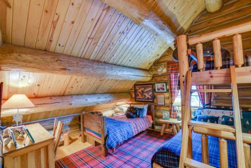 a bedroom with a bunk bed in a cabin at Handcrafted Log Home on River Near Crystal Mtn in Thompsonville