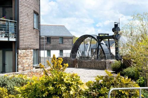 a sculpture in a garden next to a building at Wheel Water Collections in St Austell