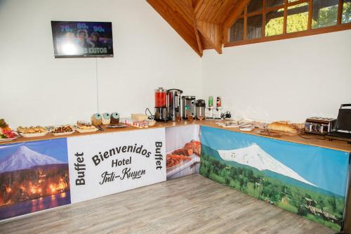 a bakery with a counter with food on it at Hotel Inti Kuyen Plaza in Pucón