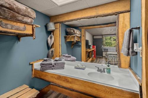 a bathroom with a sink and a mirror at Stonegate Lodge Salt Water Pool2 Queen Beds Fire Pits Fast WiFi Room #205 in Eureka Springs