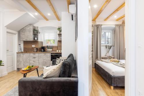 a living room with a couch and a kitchen at Nono's House I in Dubrovnik