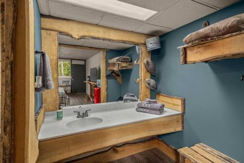 a bathroom with a sink and a mirror at Stonegate Lodge King Bed, 2mi to Historic DTWN Salt Water Pool Room #206 in Eureka Springs