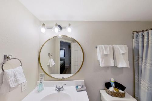a bathroom with a sink and a mirror at Lake Ozark Vista in Lake Ozark